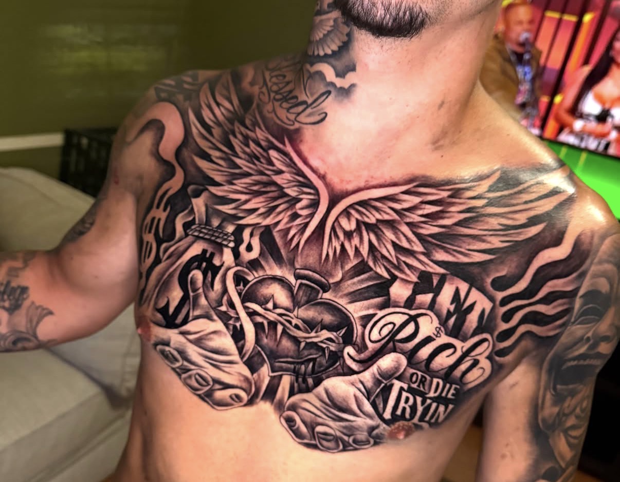 Black and gray winged sacred heart chest piece by Erick